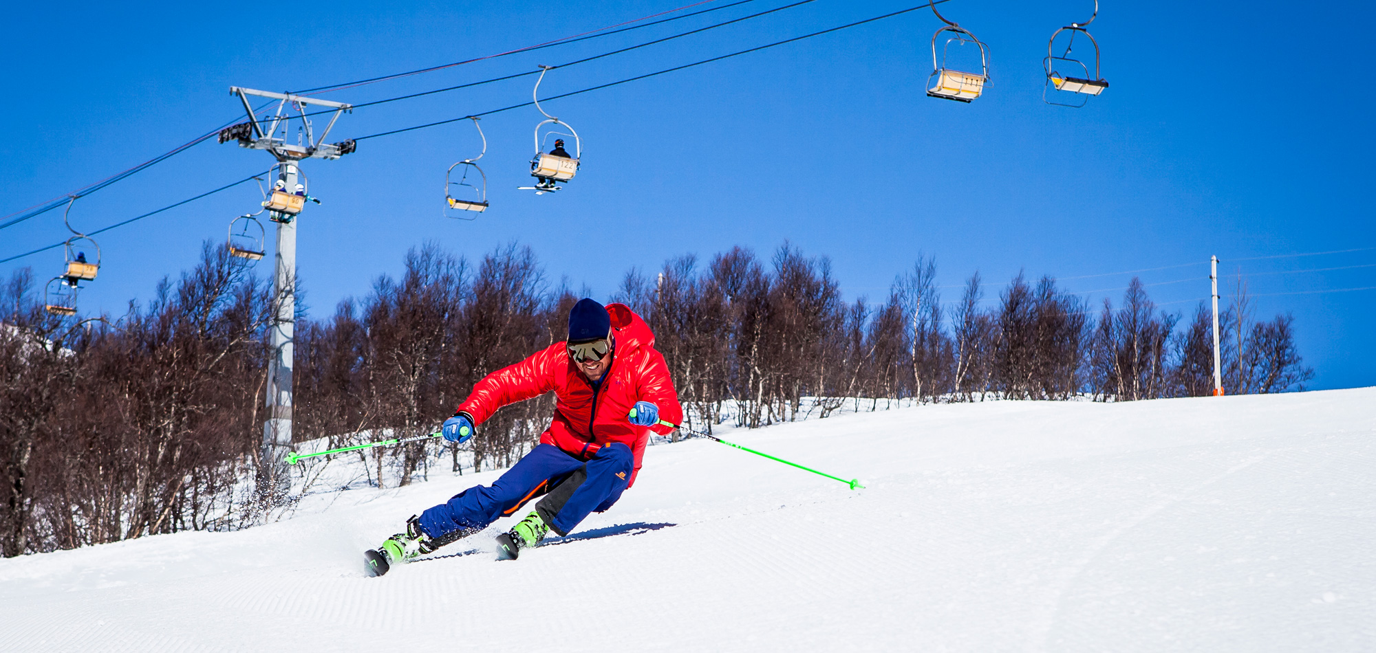 photo of man skiing in front of ski lift