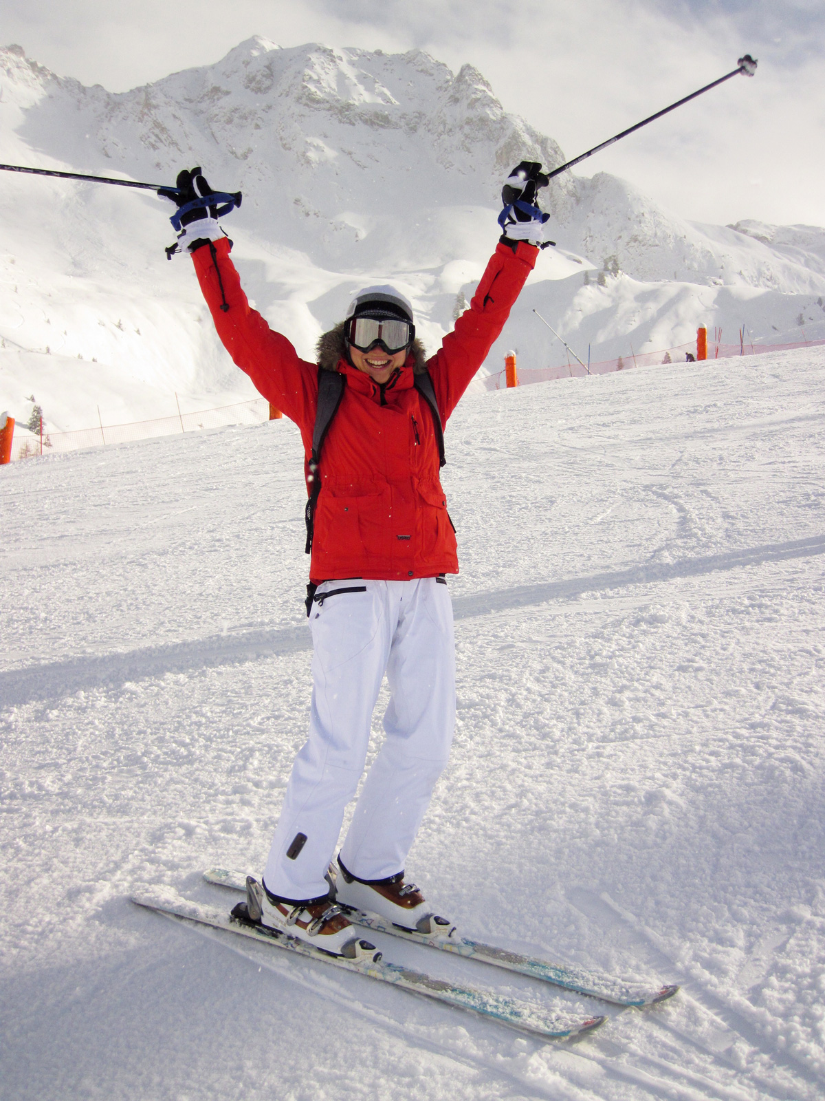 photo of a girl holding up skiers